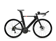 A black carbon fiber time trial bicycle with aerodynamic drop handlebars, a sleek integrated seat post, and disc brakes, shown from a side profile on a white background.