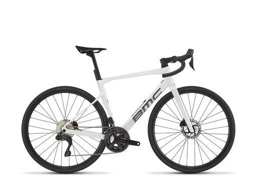 A white BMC road bicycle with black components, including the saddle, handlebars, wheels, and drivetrain, shown from a side profile on a clean white background.
