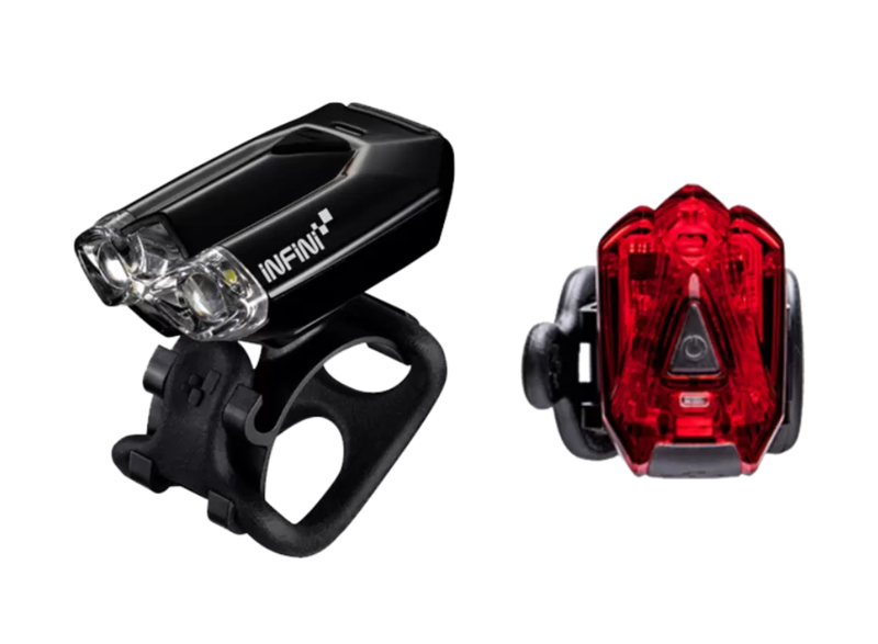 A black bicycle front light mounted on a black handlebar clamp, shown next to a red rear light on a plain white background.