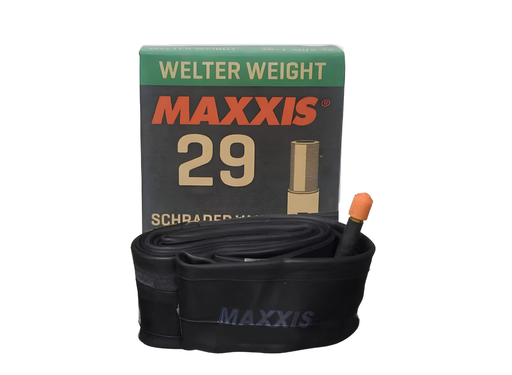 A black Maxxis 29 inner tube with an orange tip, displayed in front of its green and black retail box on a white background.