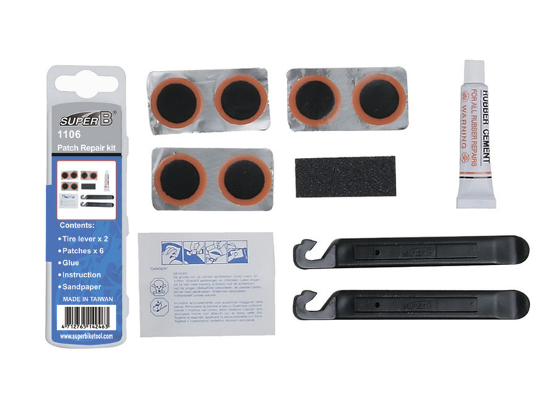 Super B 1106 Trike Level Kit patch repair kit components laid out on a white background, including two sets of black and orange patches, a tube of rubber cement, two black leveling tools, sandpaper, instruction sheet, and branded retail packaging.